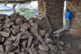 Image of a man standing next to a collapsed wall.