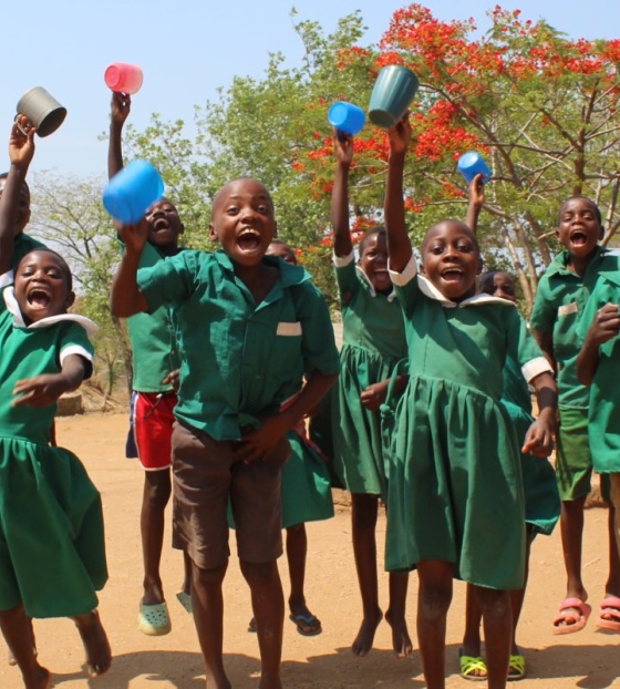 Happy children holding their cups